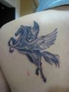 unicorn tattoos on left shoulder blade