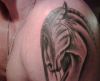 horse head tattoo on left arm