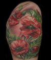 flower and ladybug arm tattoo