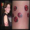 ladybug tattoo on arm of women