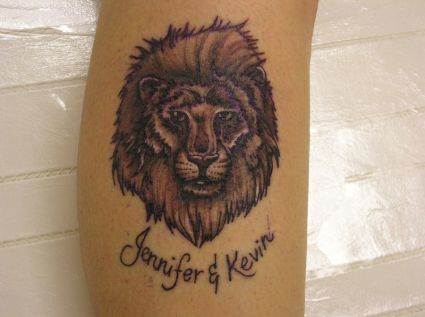 Lion Head And Text Tattoo 