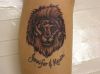 lion head and text tattoo 