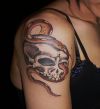 skull snake tats on shoulder