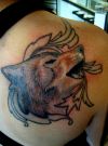 wolf head tattoo on right shoulder blade
