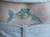 frog with leaf tattoo on lower back