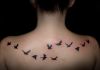 bird flying back tattoo