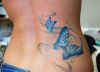 butterfly pic tattoo on side back of girl