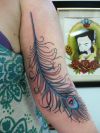 peacock feather tattoo on arm