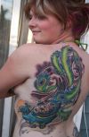 peacock tattoo on back of women