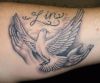 dove flying pic tattoo on arm