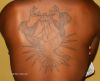 hands cross and dove pic tattoo on back
