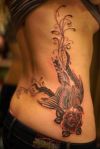 bird and rose pic tattoo on rib