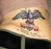 bird and text pic tattoo on lower back