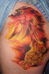 fired phoenix pic tattoo on thigh