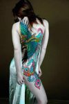 phoenix image tattoo on back of girl