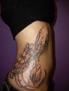 phoenix and orchid flower tattoo on side rib