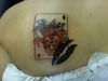 card joker tattoo on girl's back