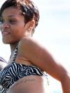 Rihanna arabic phrase "Freedom Is God" ribcage tattoo