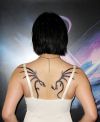 tribal dragon pic tattoo on back of girl