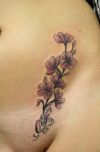 flower and chicano letter tattoo