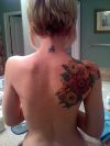 flower tattoo on left shoulder blade