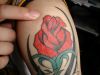 red rose tat on shoulder