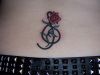 small rose lower back tattoo