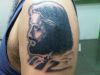 Jesus tattoo on man shoulder