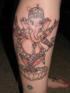 Ganesh on flower tattoo on leg