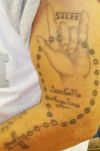 praying hand with cross amulet tattoo