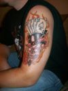 cards and skull arm tattoo