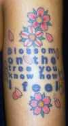 text and flower tattoo
