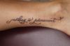 Text tattoo needled on leg