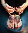 demon face tattoo on feet