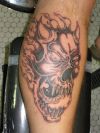 demon face tattoo on leg