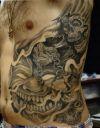 demon rib tattoo