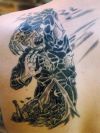 demon tattoo on left shoulder blade