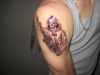grim reaper tattoo on right shoulder