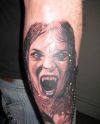 vampire girl face tattoo on elbow