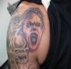 skull and vampire tattoo on shoulder