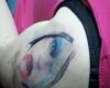 vampire girl face tattoo on arm