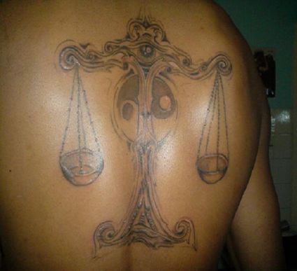 Libra Tattoo On Back Of Man