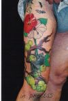 bat and fruit tattoo on leg