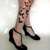 girls leg tattoo of bat