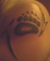 bear paw tattoo on left shoulder