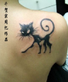 black cat on right shoulder blade