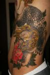 foo dog tattoo on rib