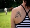 horse head left shoulder blade tattoo
