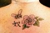 bee and flower tattoo on back
