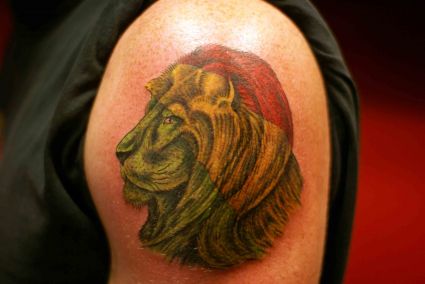 Colored Lion Head Tattoo On Arm